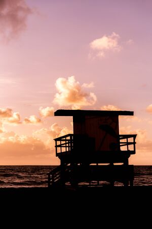 Life guard patrol hut silhouette in California during sunsetの写真素材