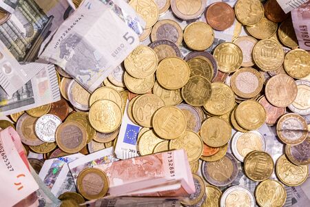 Euro money: closeup of banknotes and coins flat layの写真素材