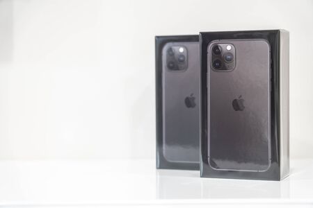 Moscow, Russia - September 24, 2019: Two New Apple iPhone 11 pro sealed in box over White Background