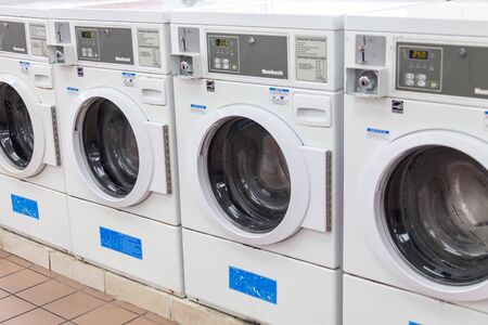 Miami, USA - September 09, 2019: industrial washing machines in a public laundromat, coin laundry serviceのeditorial素材