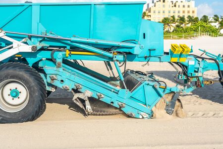 Tractor cleaning sand in South beach in Miami