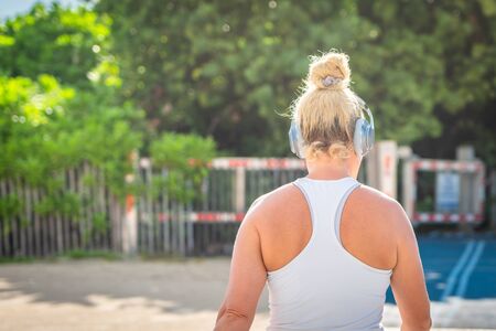 Back view of wonam walking to the beach and listening musicの写真素材