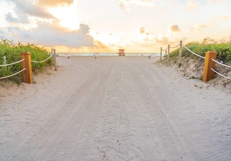 Pathway to the beach in Miami Beach Florida with ocean background at sunriseの写真素材