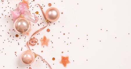 Christmas balls, pink and golden decorations on white background. top view, copy spaceの写真素材