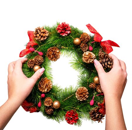 Female hands holding wreath isolated on whiteの写真素材