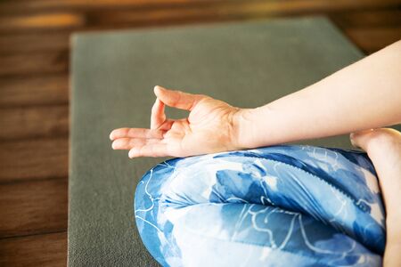 Young woman meditating sitting in lotus positionの写真素材