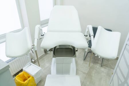 Empty white gynecological chair in a modern medical centerの写真素材
