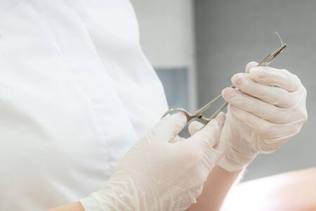 surgical forceps holding a suture needleの写真素材