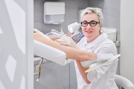 Gynecologist with vaginal speculum in clinic before patient examinationの写真素材