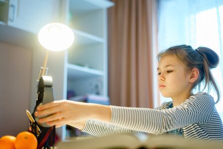 Teenage girl listening music and doing school homework, learning and studing conceptの写真素材