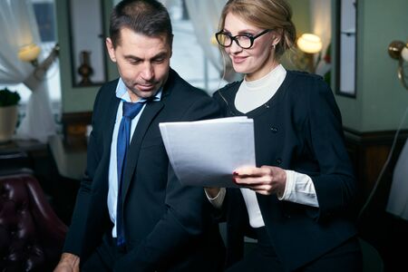 Happy Mature Businessman And Businesswoman working with documentsの写真素材