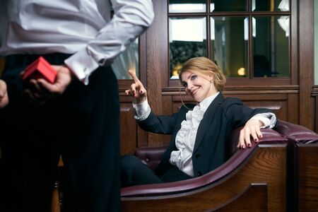 Man giving present box to a woman in restaurant