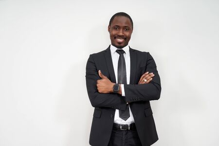 Smiling african businessman with thumbs up over grey background
