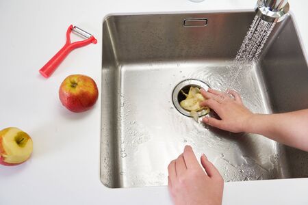 Food waste disposer machine in sink in modern kitchenの写真素材