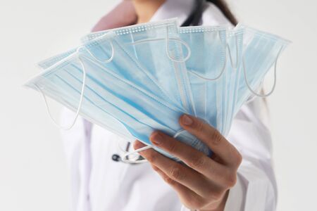 Doctor or nurse recommend to use protective face mask to protect from virus infectionの写真素材