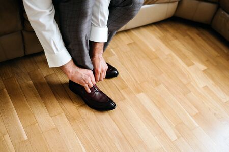 businessman putting on shoes, man getting ready for workの写真素材