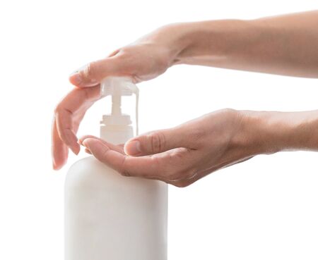 Woman hands pushing pump plastic soap bottle, isolated on white background with copy space