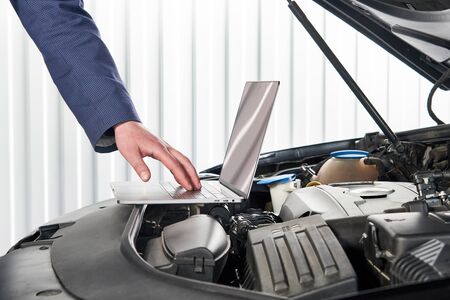 Services car engine machine concept, Automobile mechanic repairman checking a car engine with using...