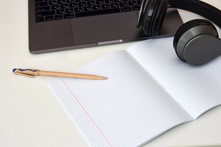 Flat lay composition with headphones, laptop and copy space