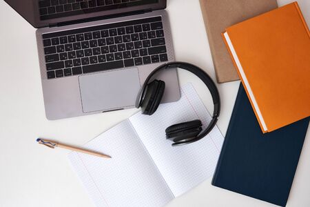 Flat lay composition with headphones, laptop and copy space