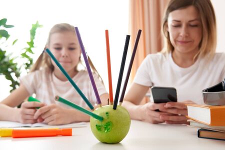 Mother and daughter having fun during remote learning at home