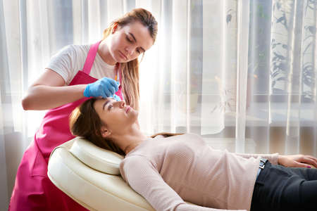 Professional eyebrow correction in beauty salon