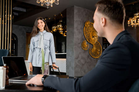 Young couple meeting in hotel lobby after separationの写真素材