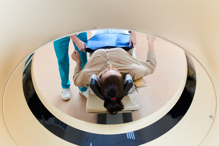 Female patient undergoing MRI - Magnetic resonance imaging in Hospital. Medical Equipment and Health Care conceptの写真素材