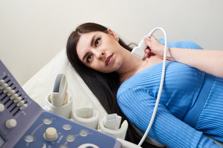 Doctor using ultrasound scanning machine examining female neck
