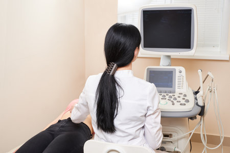 Gynecologist doing ultrasound scan in modern clinicの写真素材