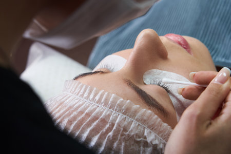 Eyelash Extension Procedure. Woman Eye with Long Eyelashesの写真素材