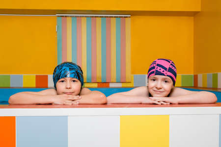 Portrait of Caucasian boy and girl in swimming pool