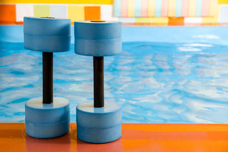 dumbbells equipment for aqua aerobics sport near swimming poolの写真素材