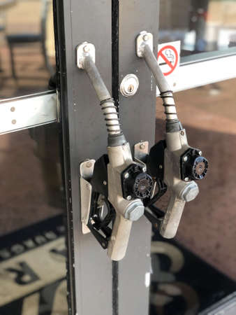 Door handle on gas station made of Gasoline pistol pump fuel nozzle