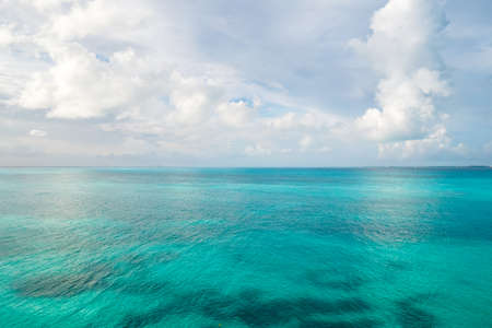 Caribbean sea surface water and sky background. Exotic landscape with clouds on horizon. Natural tropical paradise. Travel tropical island resort.の写真素材