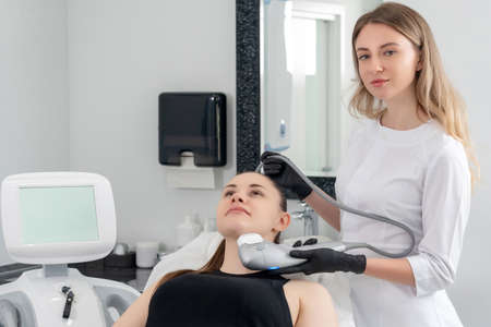 Young woman receiving laser treatment in cosmetology clinicの写真素材