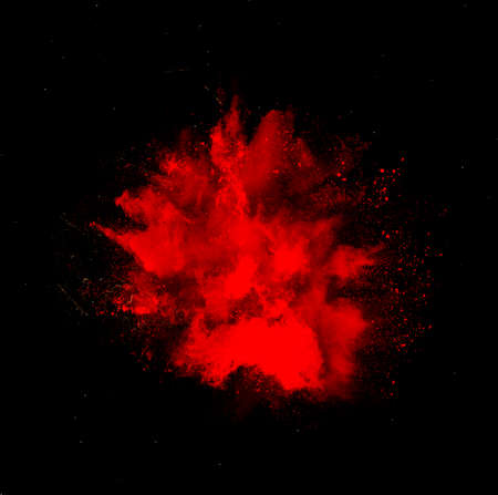 Red holi paint powder explosion isolated on black backgroundの写真素材