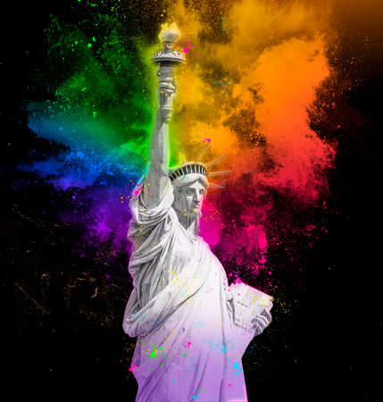 Statue of Liberty with colorful rainbow holi paint powder explosion isolated on black backgroundの写真素材