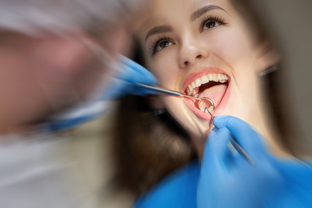 Woman having teeth check up at dentist office with motion blur effectの写真素材