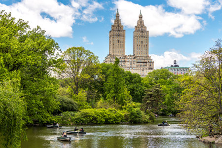 New york, USA - May 15, 2019: Row boats in lake in Central Park with Eldorado building in distance, Manhattan, New York city, USAのeditorial素材