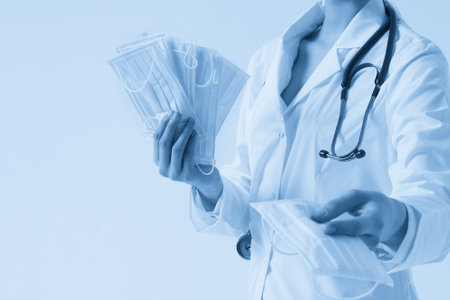 Doctor or nurse recommend to use protective face mask to protect from virus infection, coronavirus conceptの写真素材