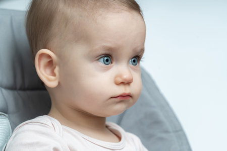 Babys thoughtful expression caught in a close-up. Concept of early contemplation and the depth of...