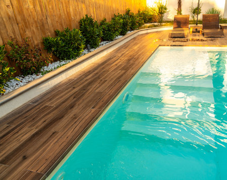 Swimming pool entrance steps with clean blue water at modern villaの写真素材