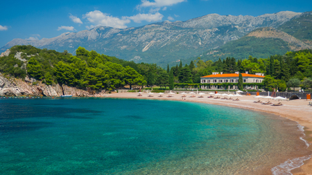 Mediterranean lagoon with turquoise water, a luxury villa and a view from the mountainsの写真素材