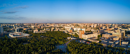 Panoramic drone view of Chelyabinsk city, huge park with mixed forest in the city center and college campus, sunny evening in the capital of South Ural, Russiaの写真素材