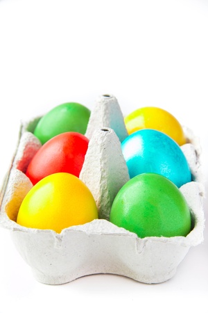 colored painted eggs in a basket の写真素材