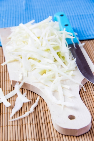 Shredded white cabbage on boardの写真素材