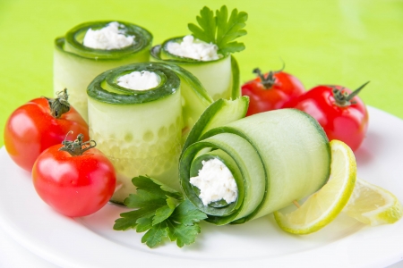 Cucumber rolls with cheese and tomato の写真素材