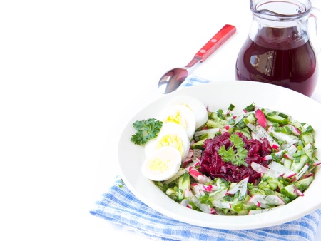 Traditional cold Lithuanian summery soup made of beets, cucumbers, egg and herbs on whiteの写真素材