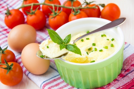 Delicate and airy steam omelet in a cup with green onions and basil for breakfastの写真素材